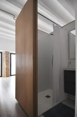 a pivot door in a room with white walls at Apartamento en Vilanova in Vilanova i la Geltrú