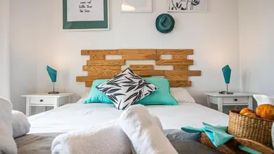 a bedroom with a bed with a wooden headboard at Bed&Bcn Glories in Barcelona