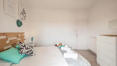 a bedroom with a large white bed with pillows at Bed&Bcn Glories in Barcelona