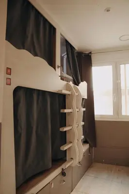 a shelf in a room with a window at Onefam Ramblas in Barcelona