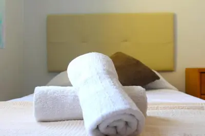 a pair of towels sitting on top of a bed at House with Pool and Sea Views in Alella
