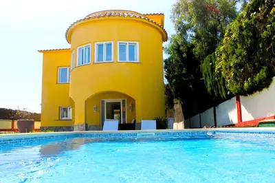 a yellow house with a swimming pool in front of it at House with Pool and Sea Views in Alella