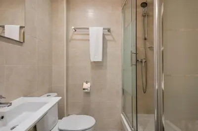 a bathroom with a shower and a toilet and a sink at Stay Together Barcelona Apartments in Barcelona