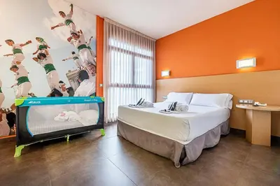 a hotel room with a bed and a tv at Hotel Pere III El Gran in Vilafranca del Penedès