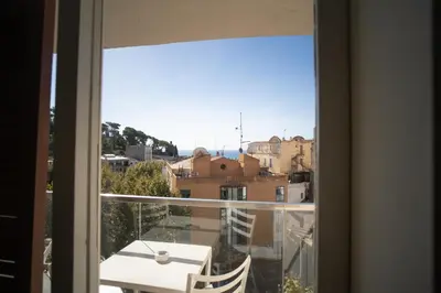 a view from a window of a balcony with a table at Dynamic Hotels Caldetes Barcelona in Caldes d'Estrac