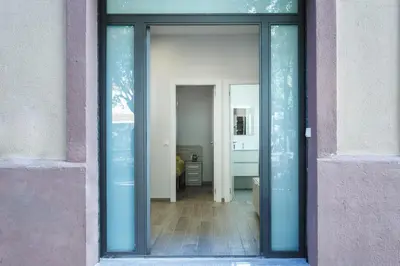 a glass doorway to a room with a hallway at Beautiful Apartment 20 minutes from city center in Hospitalet de Llobregat