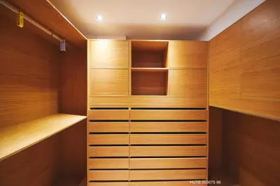 a walk in closet with wooden cabinets and shelves at Alcam Alio Cine in Barcelona