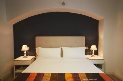 a bedroom with a large bed with two lamps at Alcam Alio Cine in Barcelona
