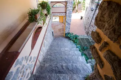 a stairway in a building with a stone wall at Loft Vacarisses Torreblanca Estación, Piscina Privada in Vacarisas