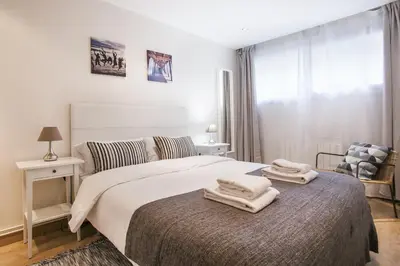 a bedroom with a bed with two towels on it at Tendency Apartments Forum 2 in Barcelona