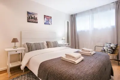a bedroom with a bed with two towels on it at Tendency Apartments Forum 2 in Barcelona