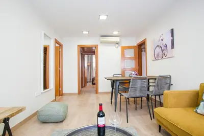 a living room with a bottle of wine on a table at Tendency Apartments Forum 2 in Barcelona