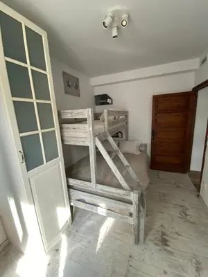 a bedroom with two bunk beds and a door at B&B Premium in Premia de Dalt