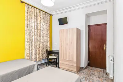 a hallway with a wooden bench in a room at Hostal Santa Ana in Barcelona