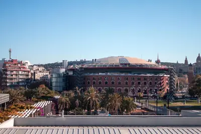 a large building with a dome on top of it at Homenfun Barcelona Plaza España in Barcelona