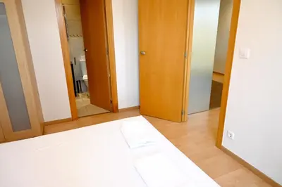 a room with a bed and a mirror at Homenfun Barcelona Plaza España in Barcelona