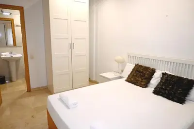 a white bedroom with a bed and a sink at Homenfun Barcelona Sagrada Familia Lepanto in Barcelona