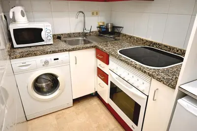 a kitchen with a washing machine and a sink at Homenfun Barcelona Sagrada Familia Lepanto in Barcelona