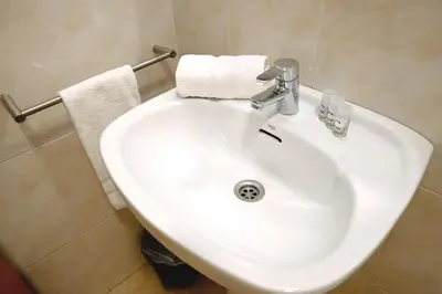 a white sink in a bathroom with towels at Homenfun Barcelona Sagrada Familia Lepanto in Barcelona