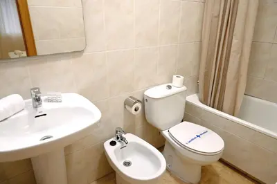 a bathroom with a toilet and a sink at Homenfun Barcelona Sagrada Familia Lepanto in Barcelona
