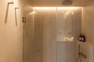 a shower with a glass door in a bathroom at Decô Apartments Barcelona-Born St. in Barcelona