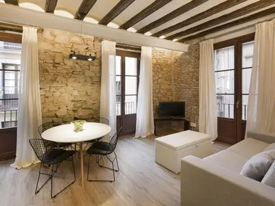 a living room with a table and a couch at Decô Apartments Barcelona-Born Apt. in Barcelona