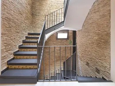 a staircase in a brick wall with a stair case at Decô Apartments Barcelona-Born Apt. in Barcelona