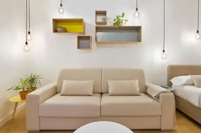 a living room with a couch and a bed at Ola Living Born in Barcelona