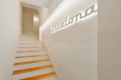 a staircase in a building with a sign on the wall at Ola Living Born in Barcelona