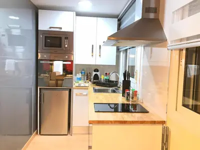 a kitchen with a stainless steel refrigerator and a sink at LOFT A 20' DE BARCELONA Y 7' DE LA UAB. in Barbera del Valles