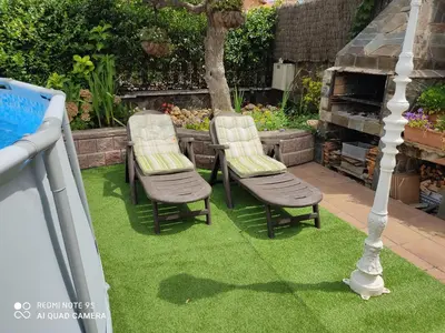 two chairs sitting on the grass in a garden at LOFT A 20' DE BARCELONA Y 7' DE LA UAB. in Barbera del Valles