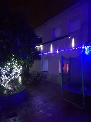a house with christmas lights on a patio at night at LOFT A 20' DE BARCELONA Y 7' DE LA UAB. in Barbera del Valles
