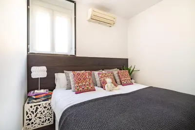 a bedroom with a bed with a teddy bear sitting on it at Luxury Penthouses 1 in Barcelona