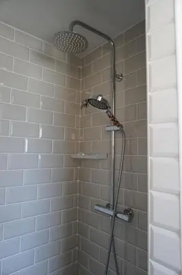 a shower with a shower head in a bathroom at BlueLine 25km BCN-Piscina, sauna y vistas al mar in Mataró