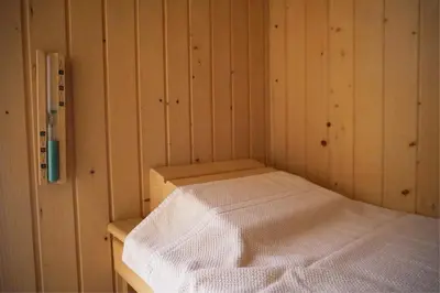 a corner of a room with a bed in it at BlueLine 25km BCN-Piscina, sauna y vistas al mar in Mataró
