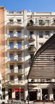 a large white building with balconies on the side of it at Enjoybcn Gaudi Apartments in Barcelona