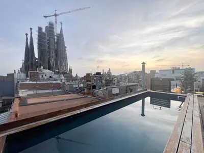 a rooftop pool with a view of the city at Enjoybcn Gaudi Apartments in Barcelona