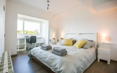 a bedroom with a large bed with two pillows on it at GAVA4 BEACHFRONT Apartment BARCELONA in Gavà