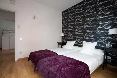 a bedroom with a large bed with a black wall at AB Gracia Sant Salvador in Barcelona