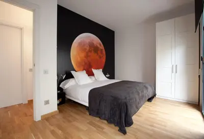 a bedroom with a bed with a large painting on the wall at AB Gracia Sant Salvador in Barcelona