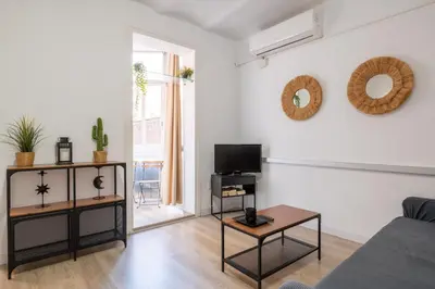 a living room with a couch and a tv at Sagrada Familia Comfy apartment in Barcelona