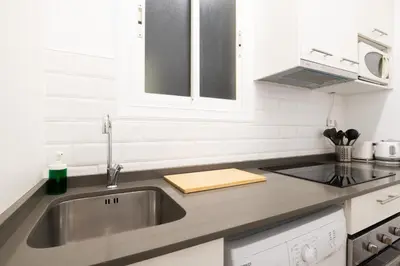 a bedroom with a bed and a picture on the wall at Sagrada Familia Comfy apartment in Barcelona