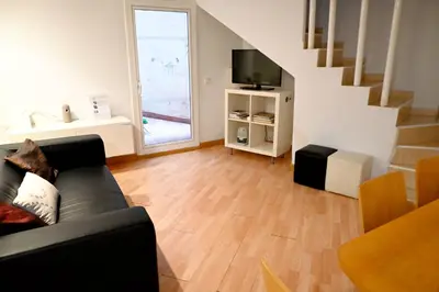 a living room with a couch and a television at Homenfun Barcelona Sagrada Familia Glories in Barcelona