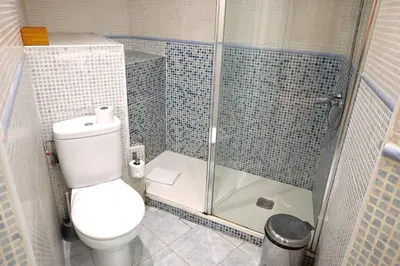 a bathroom with a toilet and a glass shower at Homenfun Barcelona Sagrada Familia Glories in Barcelona