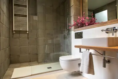 a bathroom with a shower and a toilet and a sink at Inspired by EnjoyApartments in Barcelona