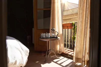 a table with glasses on it next to a door at Inspired by EnjoyApartments in Barcelona