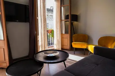 a living room with a couch and a table at Inspired by EnjoyApartments in Barcelona