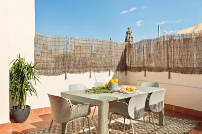 a dining room with a white table and chairs at Inspired by EnjoyApartments in Barcelona