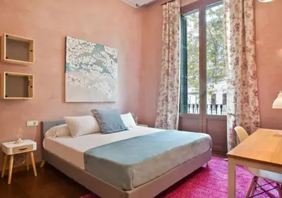 a bedroom with a bed and a desk and a window at Midtown Luxury Apartments by Sweett in Barcelona