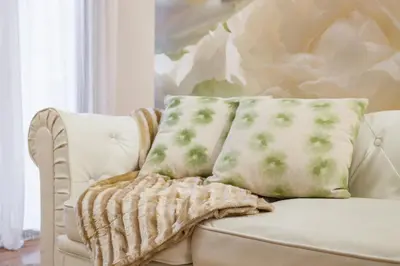 a white couch with two pillows on it at Art House Sagrada Familia in Barcelona